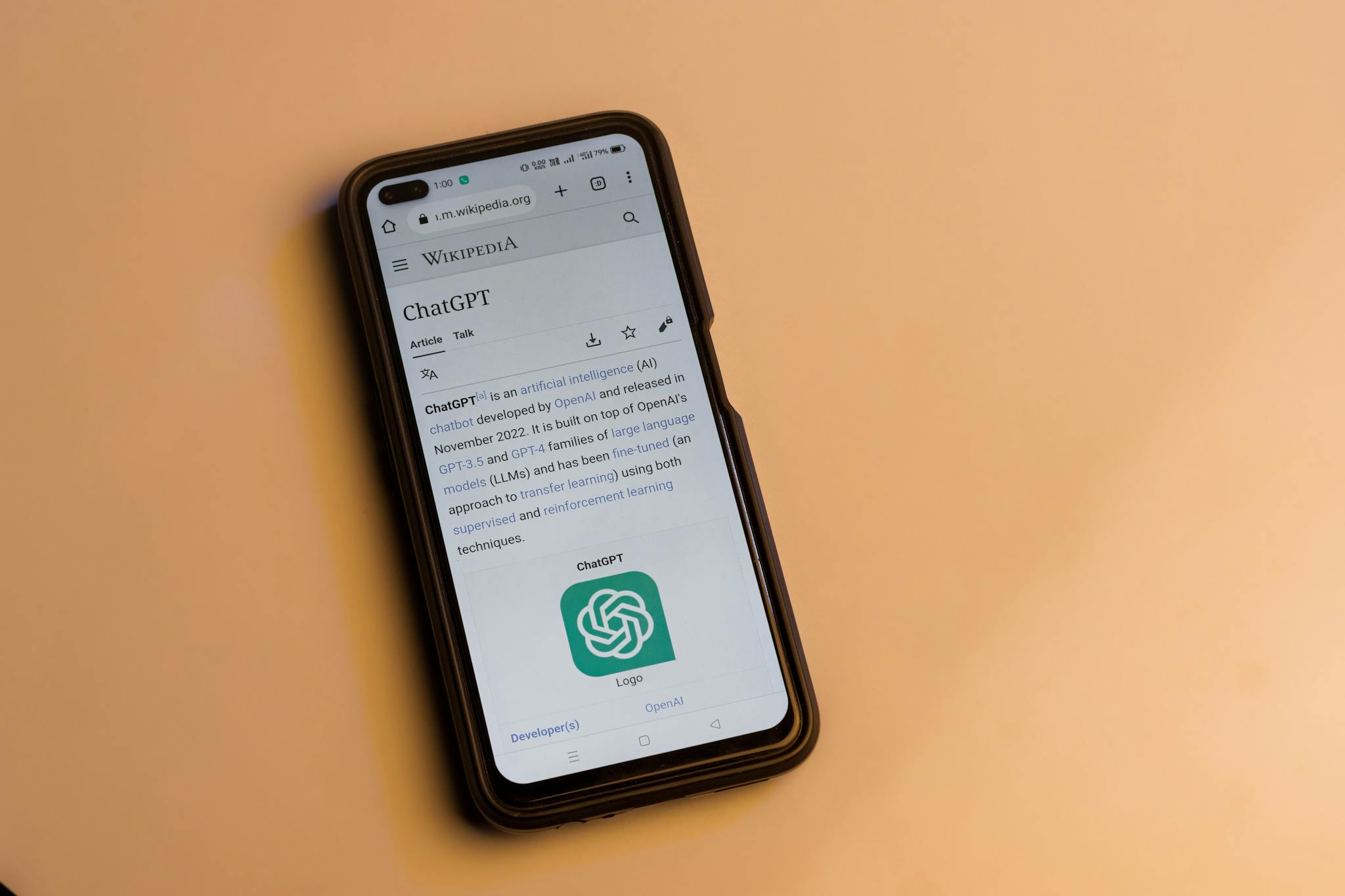 A smartphone displaying the Wikipedia page for ChatGPT, illustrating its technology interface.